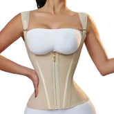 Woman wearing a beige compression garment with a white bra on a gray background
